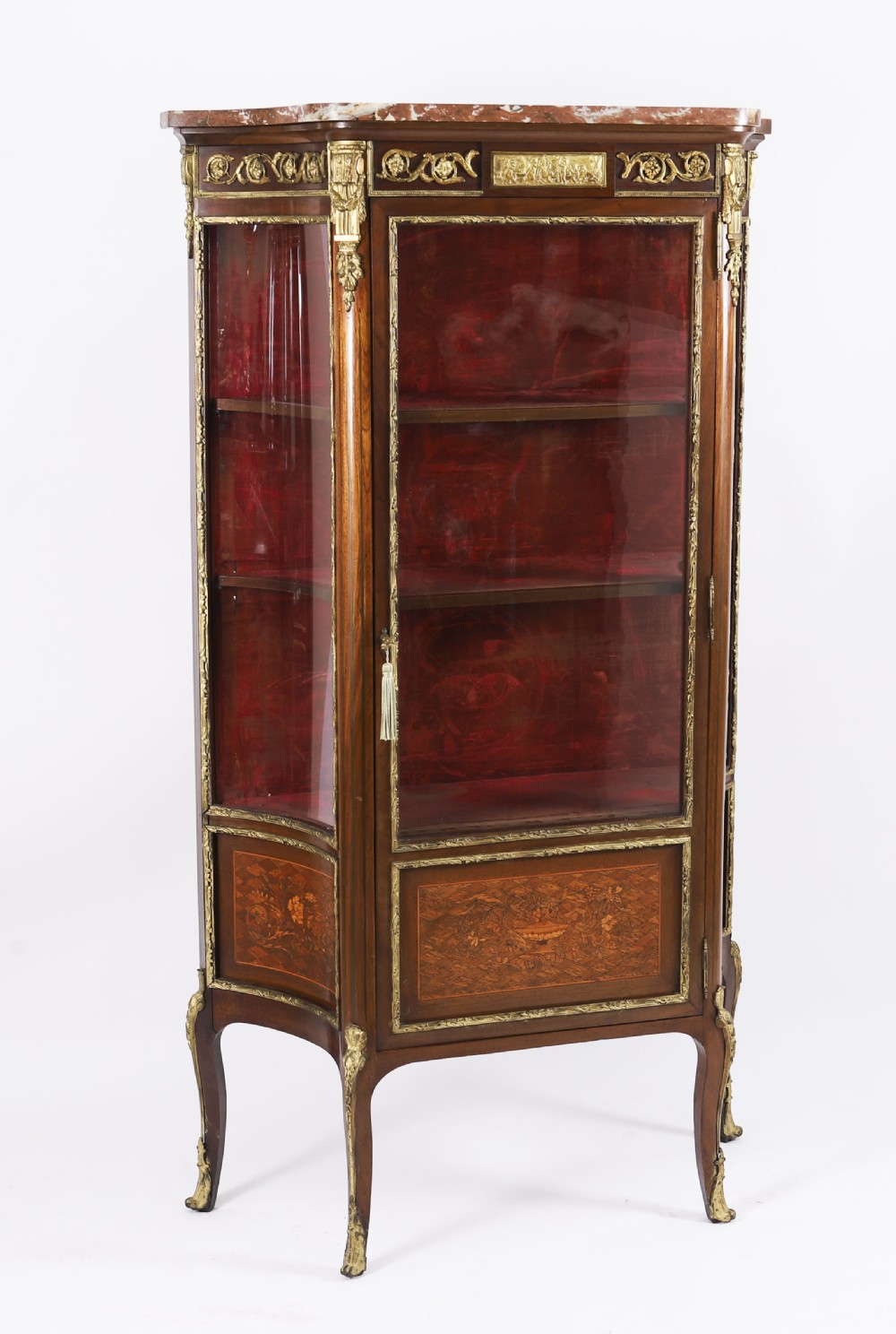 A 19th-century French Louis Revival vitrine cabinet featuring a marble top, glazed glass sides and door, floral marquetry panels, and ornate gilt bronze mounts. View XVIII