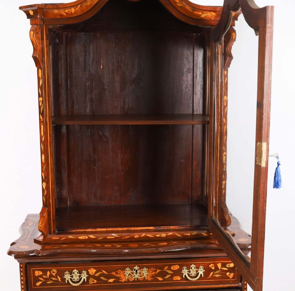 An 18th-century Dutch walnut cabinet on chest featuring detailed floral marquetry inlay, an arched bonnet top with glass doors, and four brass-handled drawers. View VI