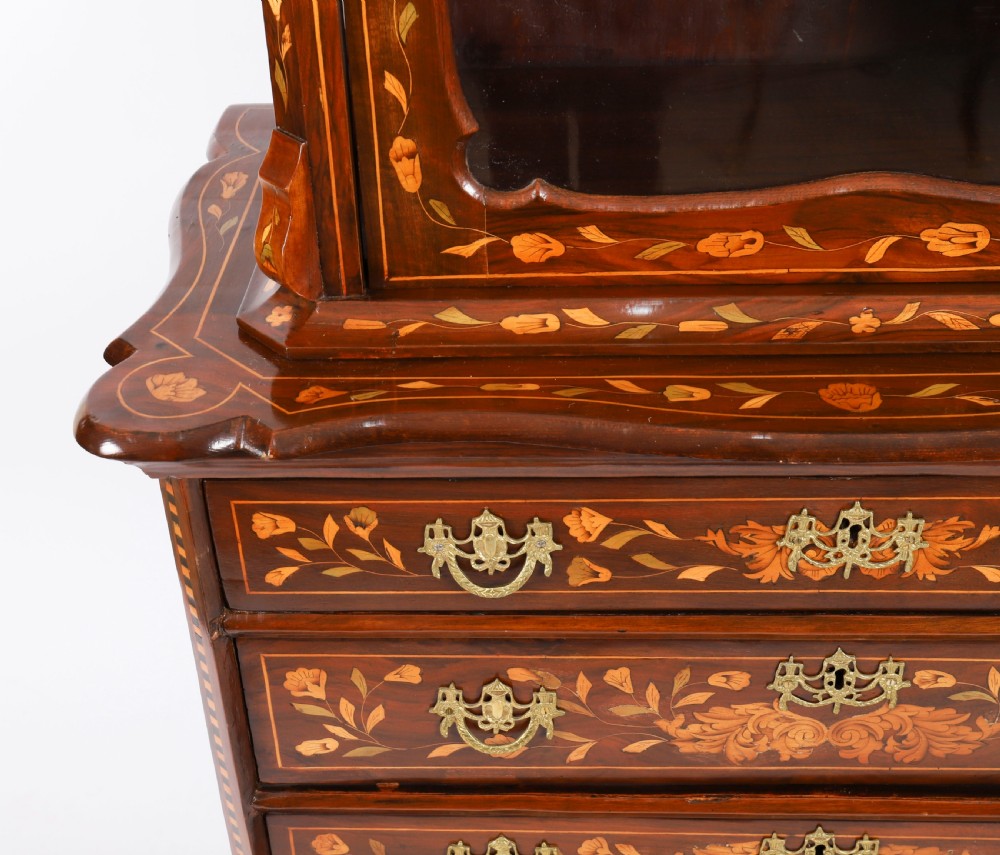 An 18th-century Dutch walnut cabinet on chest featuring detailed floral marquetry inlay, an arched bonnet top with glass doors, and four brass-handled drawers. View IX