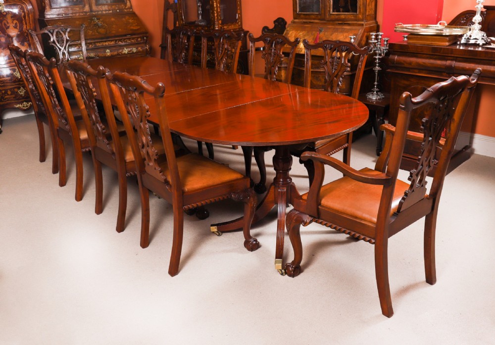 A large George IV Regency mahogany extended dining table featuring three pedestal supports with reeded legs and brass castors. View III