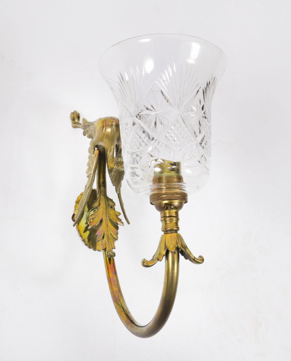 A set of six Neo-Classical brass wall sconces featuring sculpted griffin mounts, curved arms, and flared cut-glass bell shades. View V