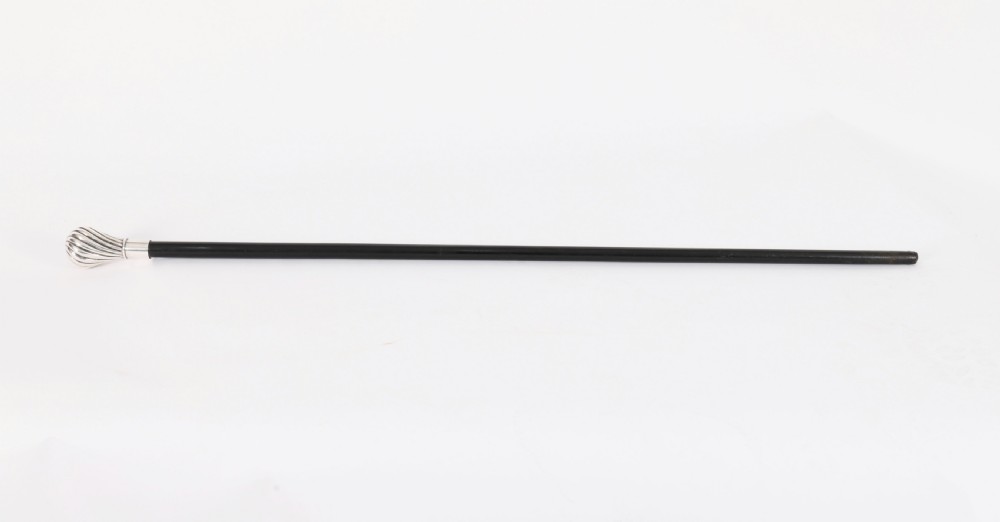 An antique French walking cane featuring a black ebonised shaft and a silver-plated fluted pommel handle.