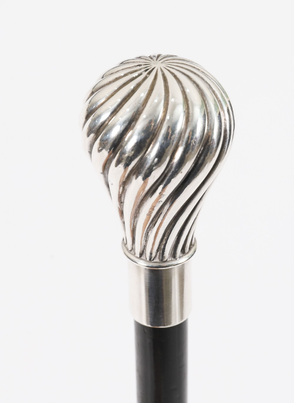 An antique French walking cane featuring a black ebonised shaft and a silver-plated fluted pommel handle. View II