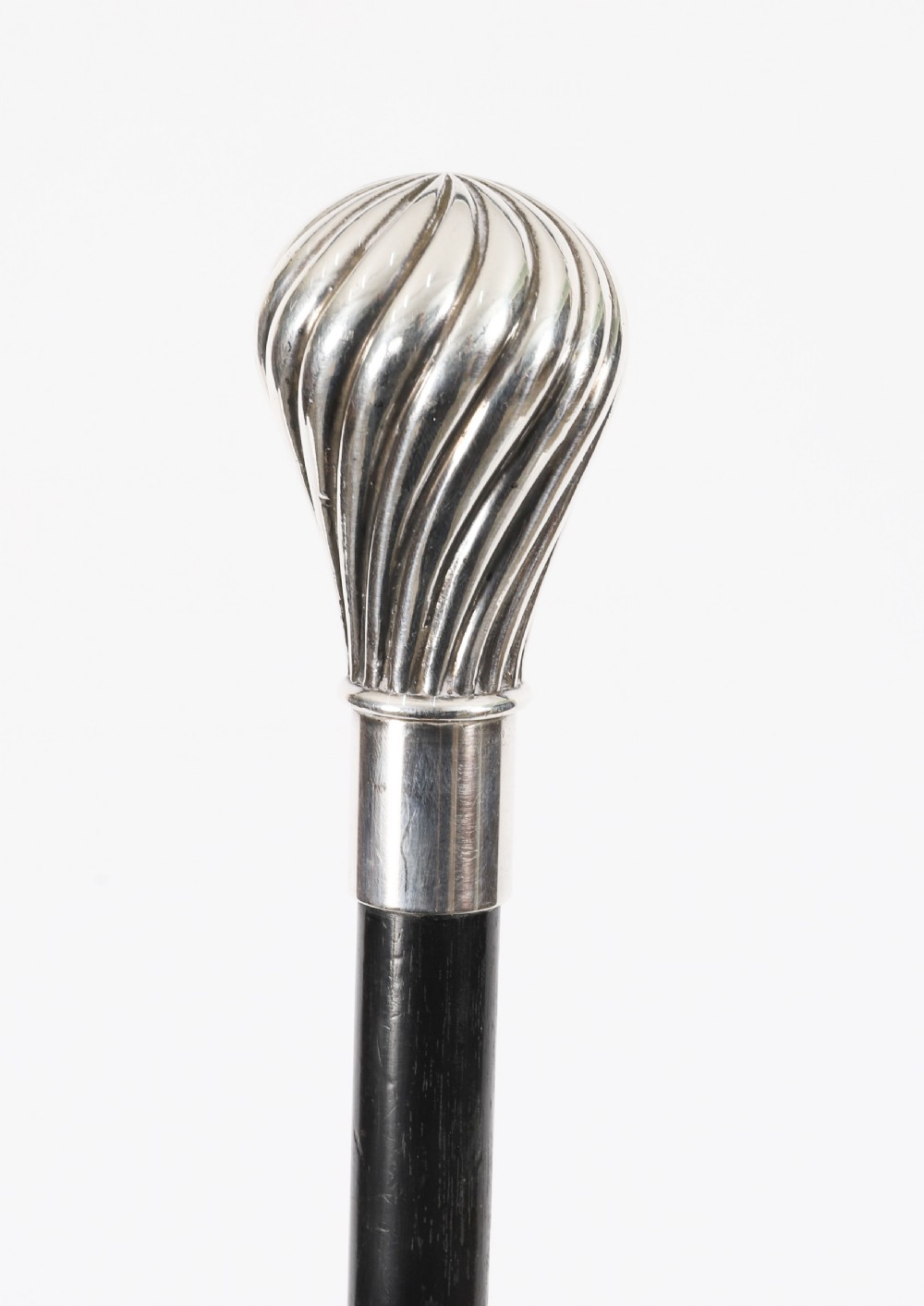 An antique French walking cane featuring a black ebonised shaft and a silver-plated fluted pommel handle. View VII