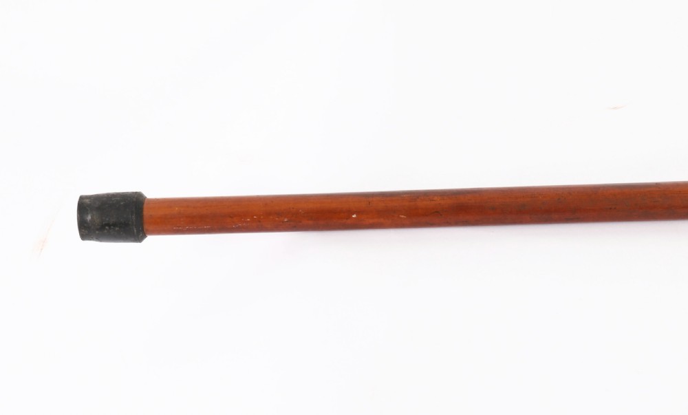 An antique walking stick featuring an elaborately chased silver pommel handle with foliate motifs mounted on a smooth light timber shaft. View VI