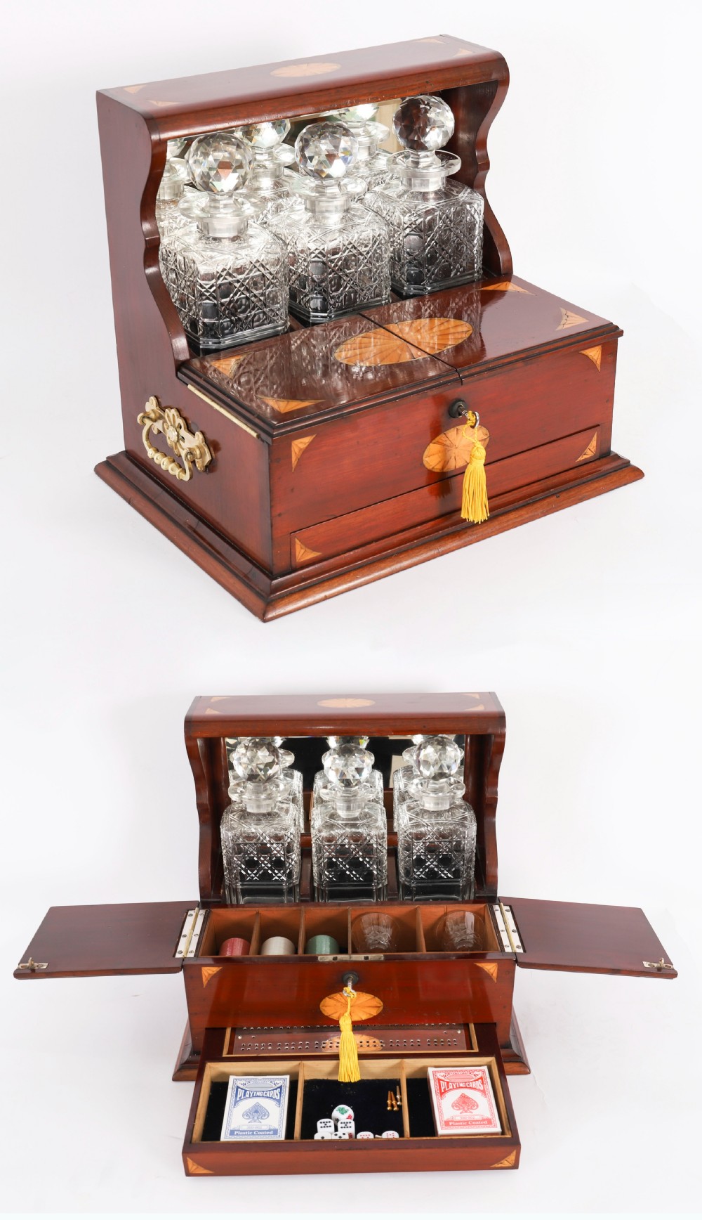 A 19th-century inlaid satinwood and mahogany tantalus containing three cut crystal decanters with faceted stoppers, a mirrored back interior, and a lower fold-out compartment with oval marquetry paterae. View XX