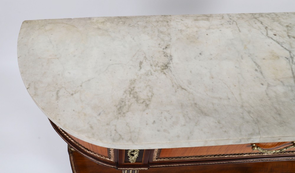 A pair of 19th-century French Louis XVI style demi-lune console tables with white Carrara marble tops, gilt bronze mounts, fluted legs, and undershelves. View IV