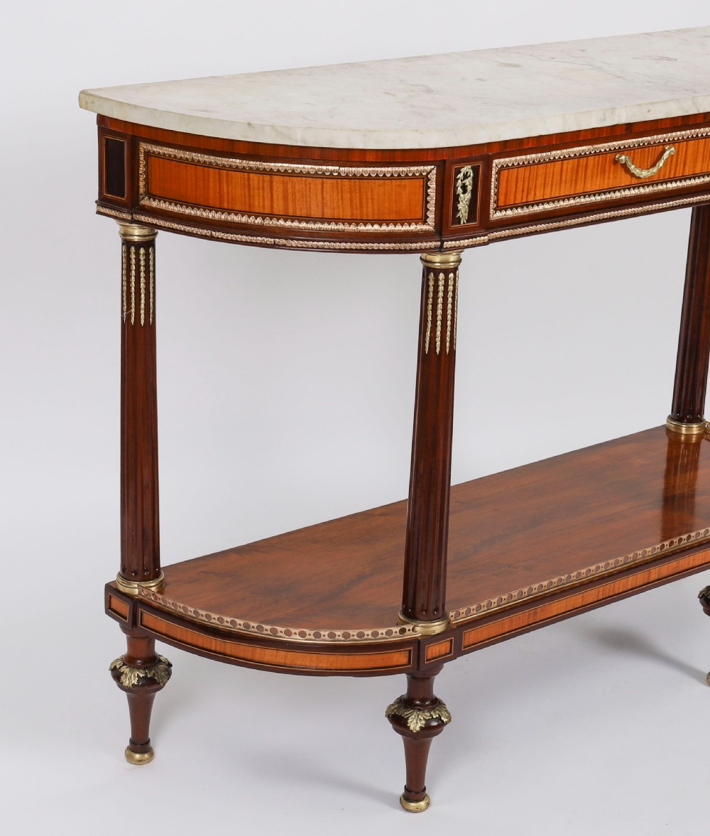 A pair of 19th-century French Louis XVI style demi-lune console tables with white Carrara marble tops, gilt bronze mounts, fluted legs, and undershelves. View XIII