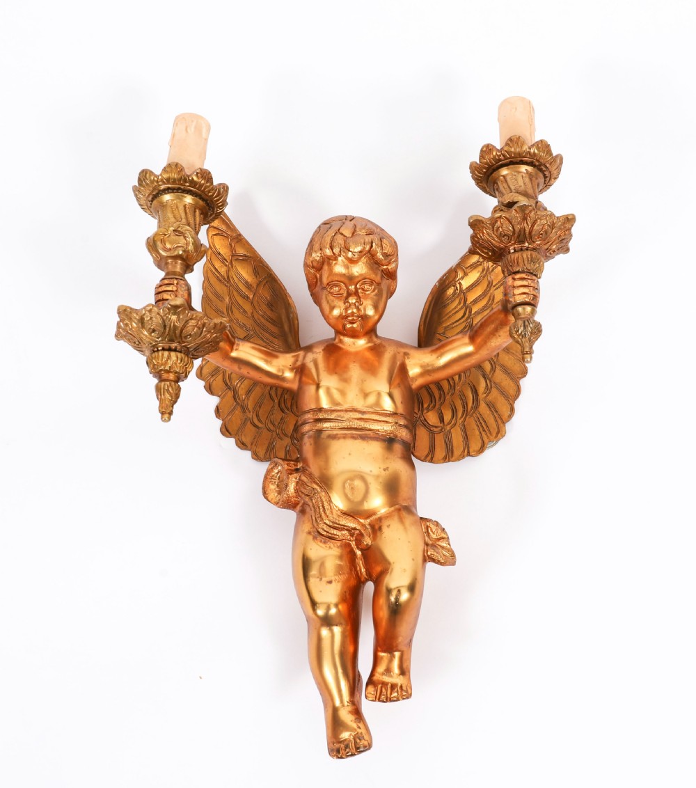 A pair of nineteenth-century gilt metal two-branch wall sconces featuring sculpted winged cherubs holding torch-shaped candleholders. View II