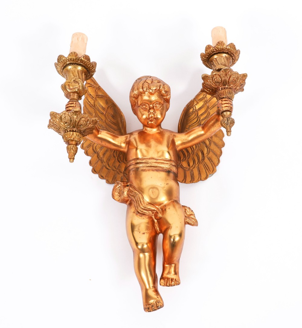A pair of nineteenth-century gilt metal two-branch wall sconces featuring sculpted winged cherubs holding torch-shaped candleholders. View VI
