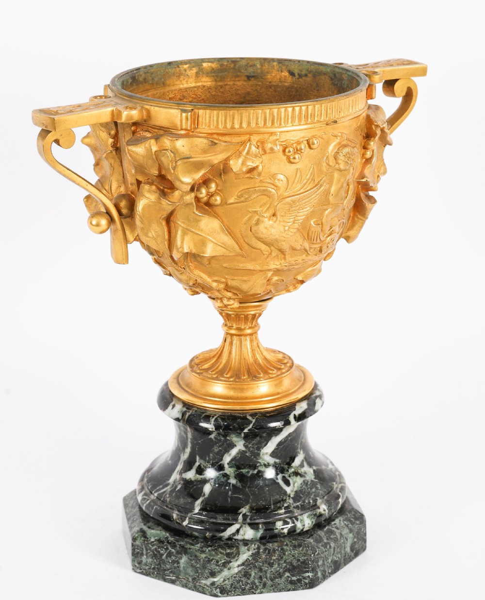 A pair of nineteenth-century French gilt bronze classical urns featuring relief carvings and scroll handles, mounted on dark green marble bases. View V