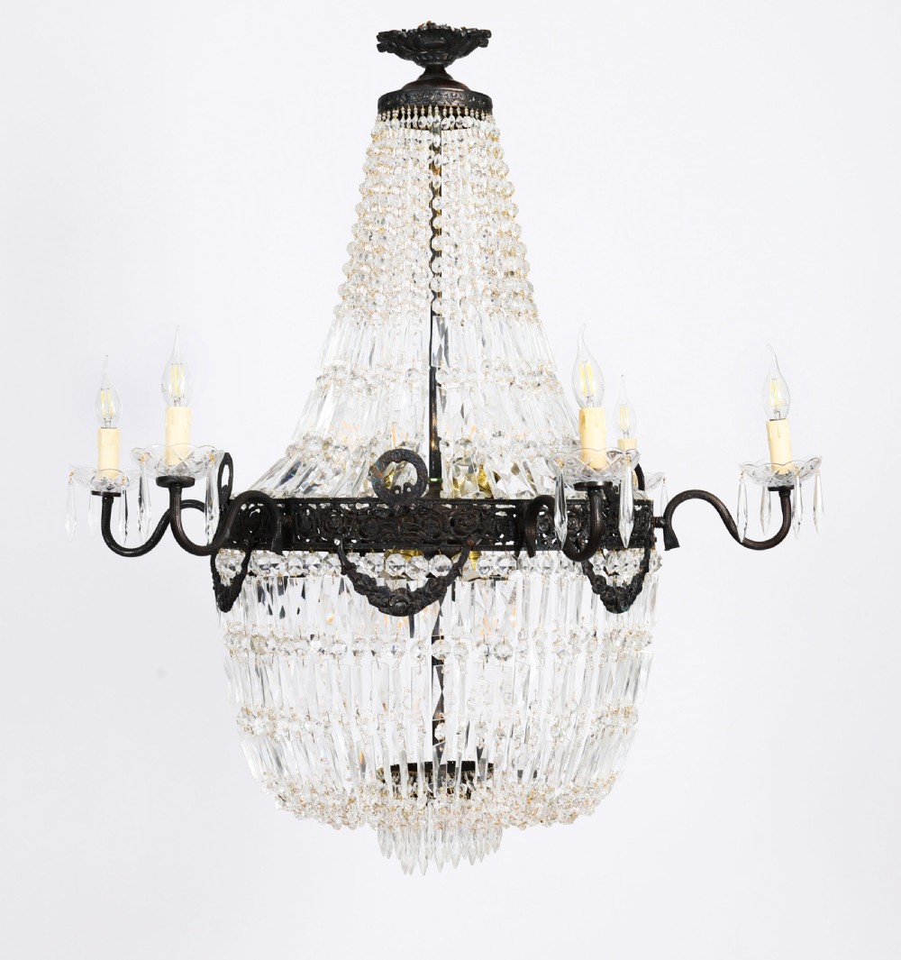 A pair of French Louis Revival tent and bag style chandeliers featuring tiered crystal bead cascades, dark bronze metal bands with floral festoons, and extending candle arms. View III