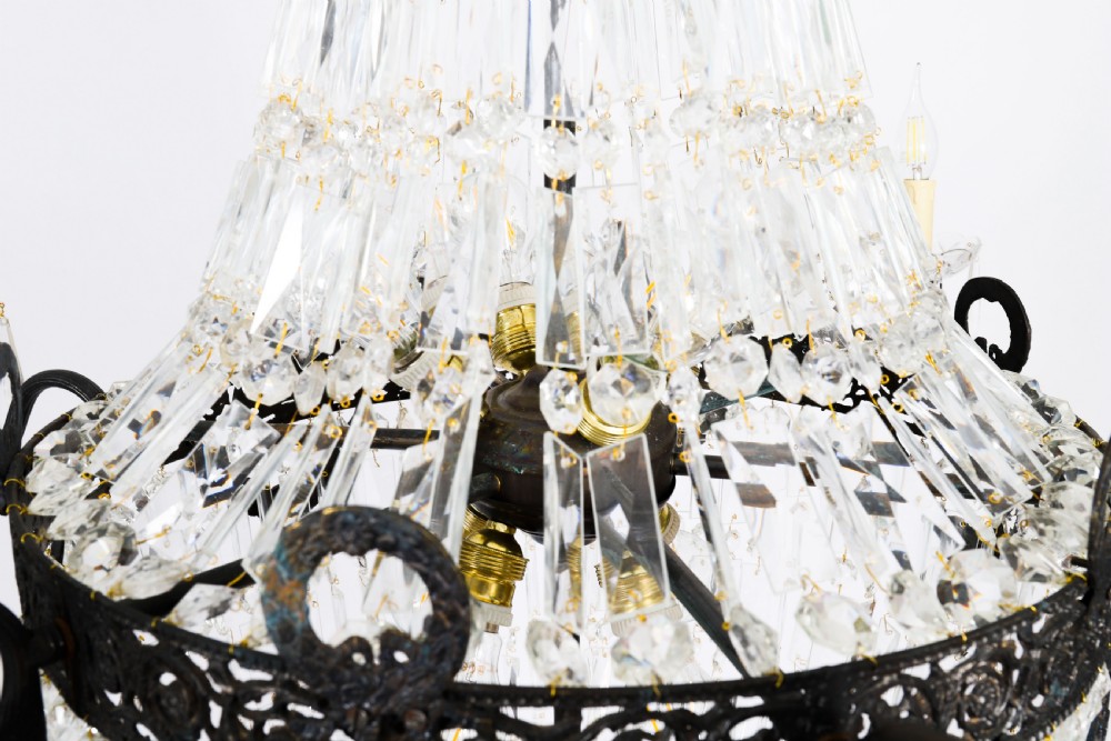 A pair of French Louis Revival tent and bag style chandeliers featuring tiered crystal bead cascades, dark bronze metal bands with floral festoons, and extending candle arms. View VIII