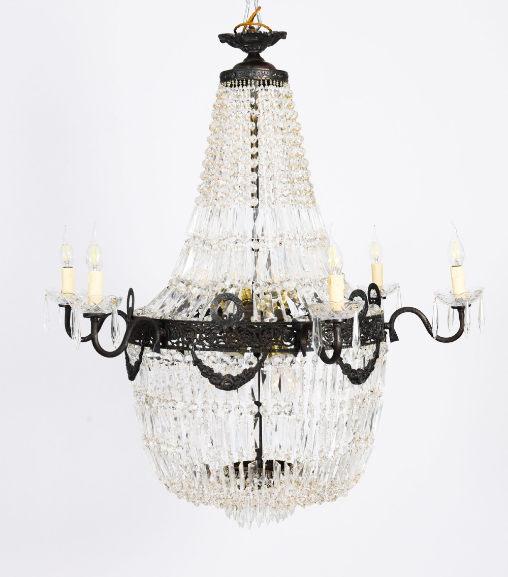 A pair of French Louis Revival tent and bag style chandeliers featuring tiered crystal bead cascades, dark bronze metal bands with floral festoons, and extending candle arms. View XIV