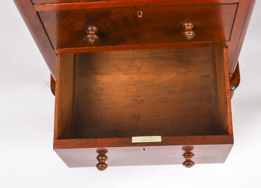 A Victorian flame mahogany partners pedestal desk fitted with a green leather inset top and wooden knob drawer pulls. View XVIII