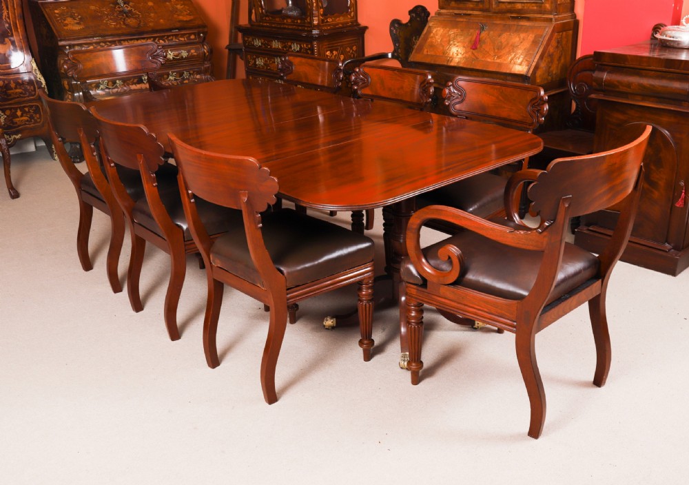 A George III Regency period mahogany twin pillar dining table featuring reeded edge detail and tripod pedestal legs with brass castors. View III