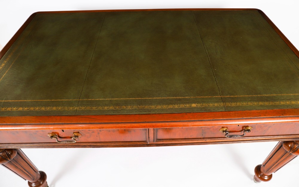 Nineteenth-century Victorian mahogany writing table featuring a green leather inset top, two drawers with brass drop handles, and carved turned legs on brass castors. View III