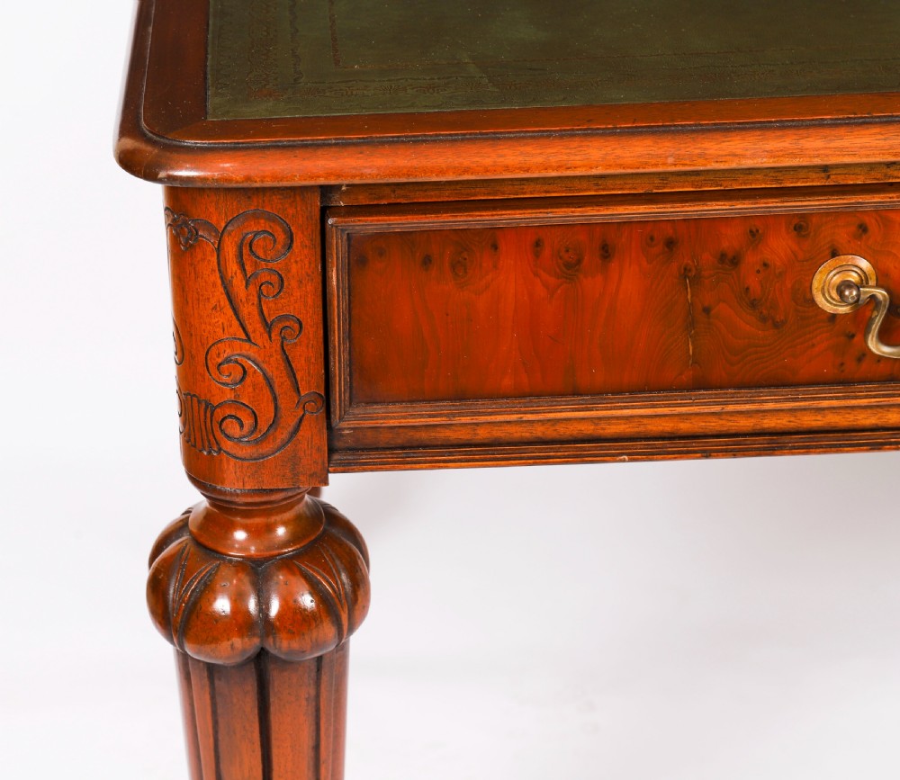 Nineteenth-century Victorian mahogany writing table featuring a green leather inset top, two drawers with brass drop handles, and carved turned legs on brass castors. View XVII