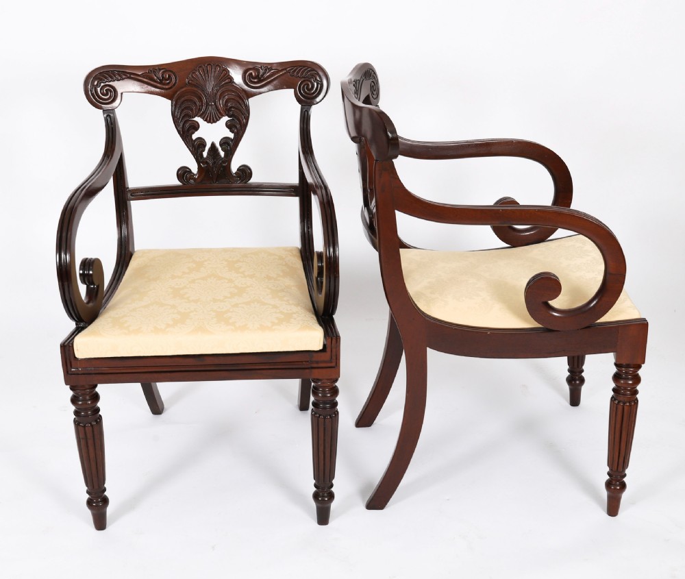 A set of twelve nineteenth-century Irish Regency mahogany dining chairs with carved shell back crests and cream upholstered seats. View XI
