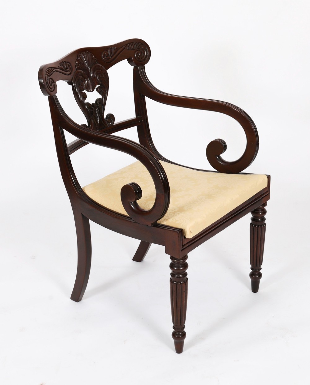 A set of twelve nineteenth-century Irish Regency mahogany dining chairs with carved shell back crests and cream upholstered seats. View XII