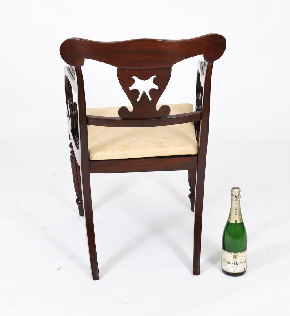 A set of twelve nineteenth-century Irish Regency mahogany dining chairs with carved shell back crests and cream upholstered seats. View XVII
