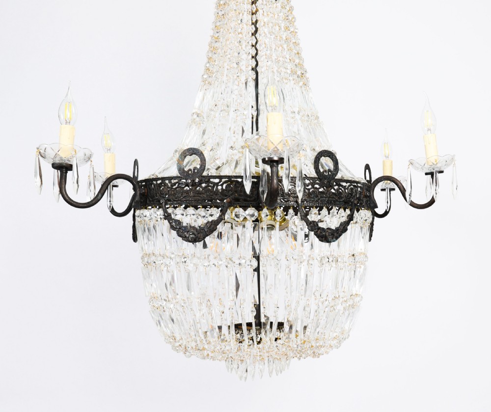 A set of six Louis XVI Revival cut crystal tent and bag chandeliers featuring dark metal frames and perimeter candle sockets on scrolling arms. View XIII
