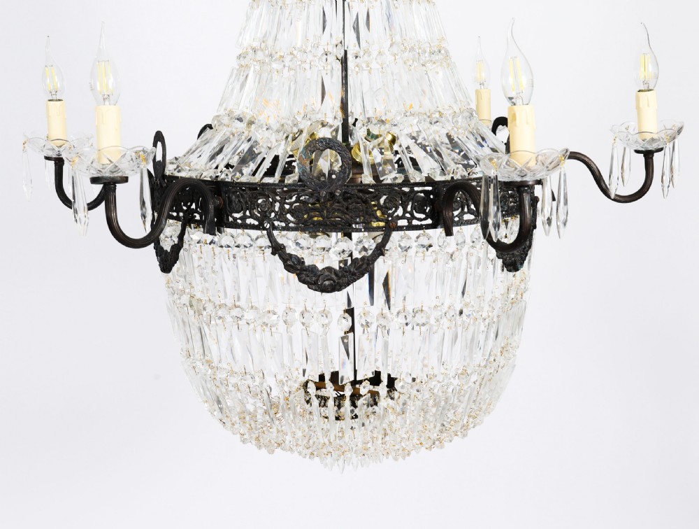 A set of six Louis XVI Revival cut crystal tent and bag chandeliers featuring dark metal frames and perimeter candle sockets on scrolling arms. View XV