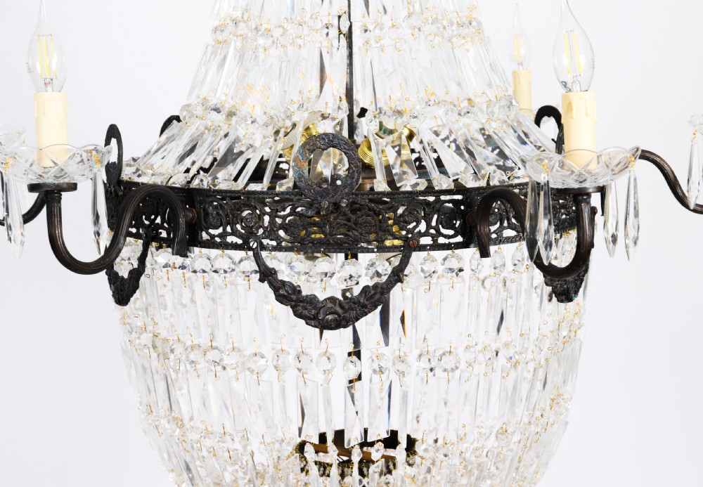 A set of six Louis XVI Revival cut crystal tent and bag chandeliers featuring dark metal frames and perimeter candle sockets on scrolling arms. View XVI