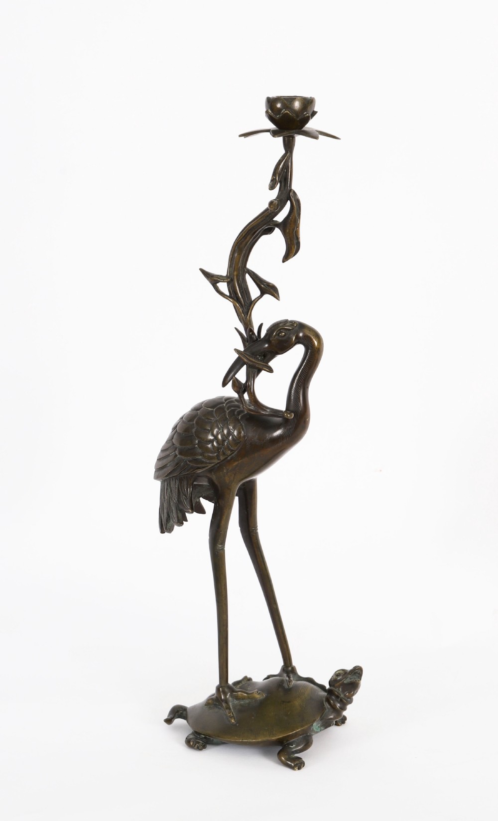 A pair of 19th-century Japanese dark bronze pricket candlesticks formed as cranes standing on tortoises holding lotus stems in their beaks. View II