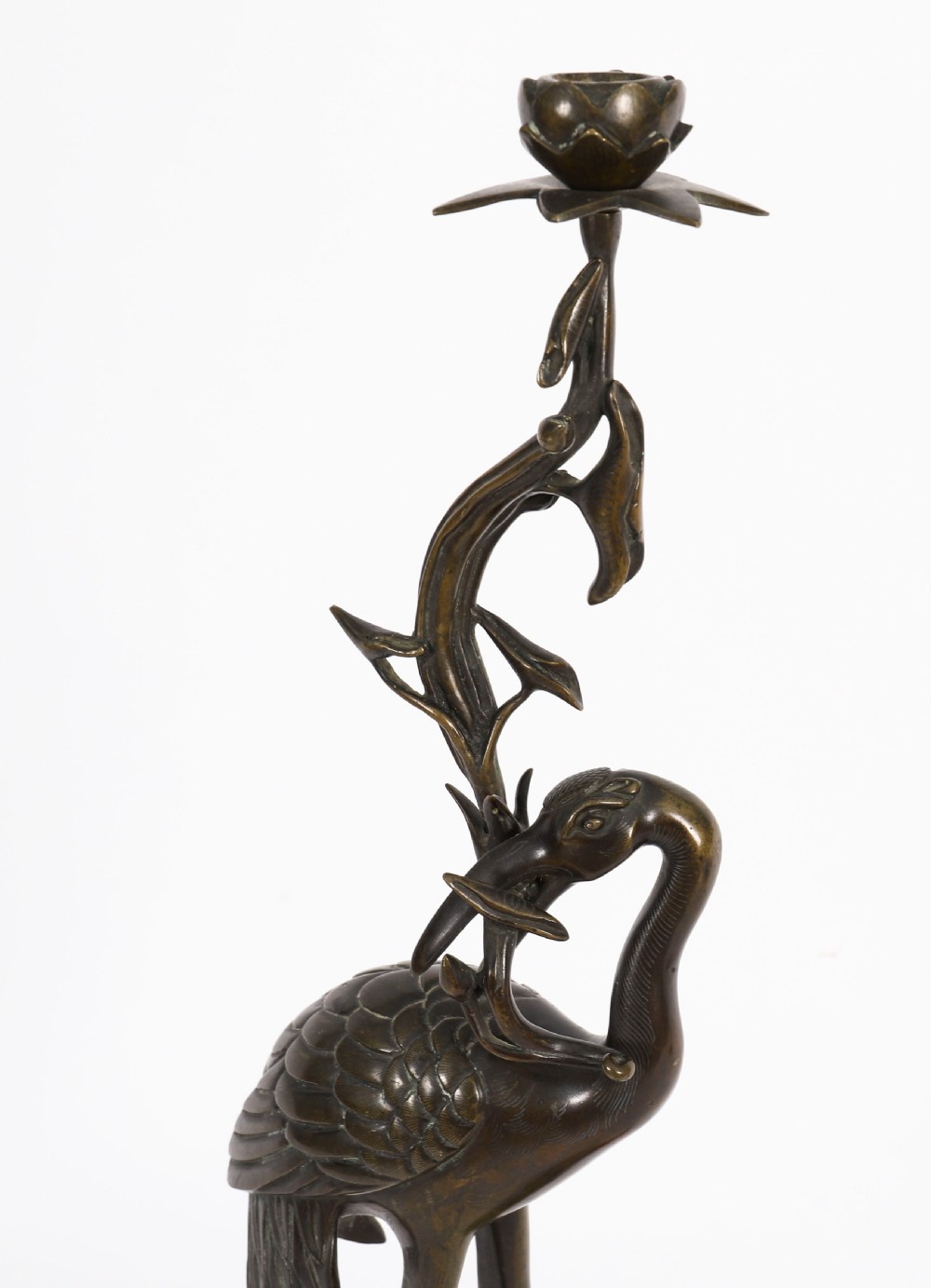 A pair of 19th-century Japanese dark bronze pricket candlesticks formed as cranes standing on tortoises holding lotus stems in their beaks. View V