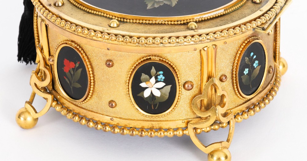 A circular 19th-century ormolu jewellery casket featuring fine Pietra Dura floral and fruit stone inlays set into gilt bronze with a key and tassel. View VII