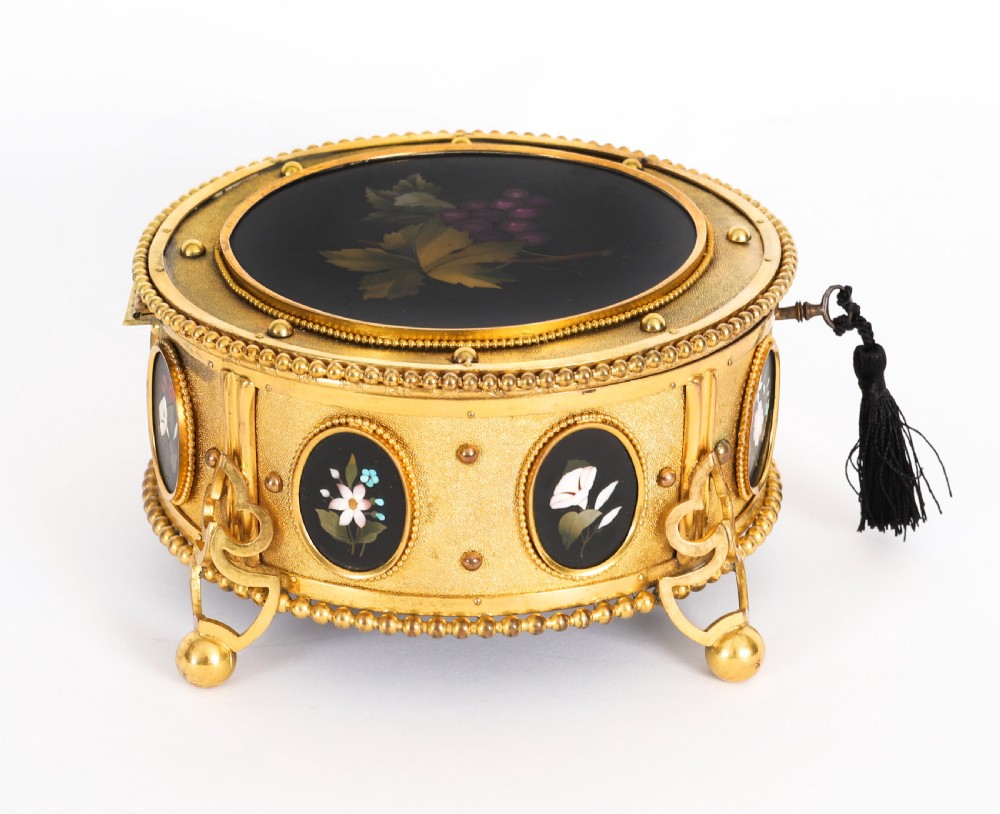 A circular 19th-century ormolu jewellery casket featuring fine Pietra Dura floral and fruit stone inlays set into gilt bronze with a key and tassel. View VIII