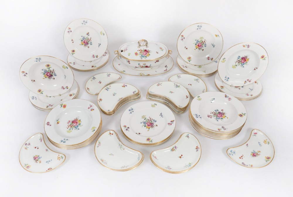 A 60-piece Victorian Copeland Spode white porcelain dinner service decorated with hand-painted floral bouquets, gilt rims, plates, crescent side dishes, and a covered tureen.