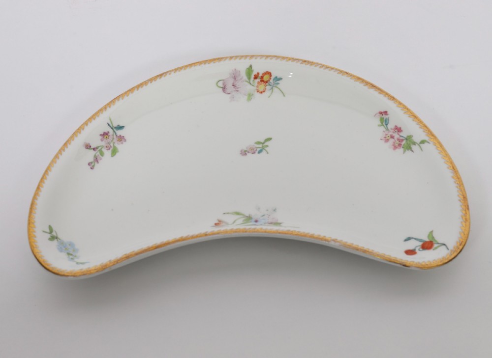 A 60-piece Victorian Copeland Spode white porcelain dinner service decorated with hand-painted floral bouquets, gilt rims, plates, crescent side dishes, and a covered tureen. View XII