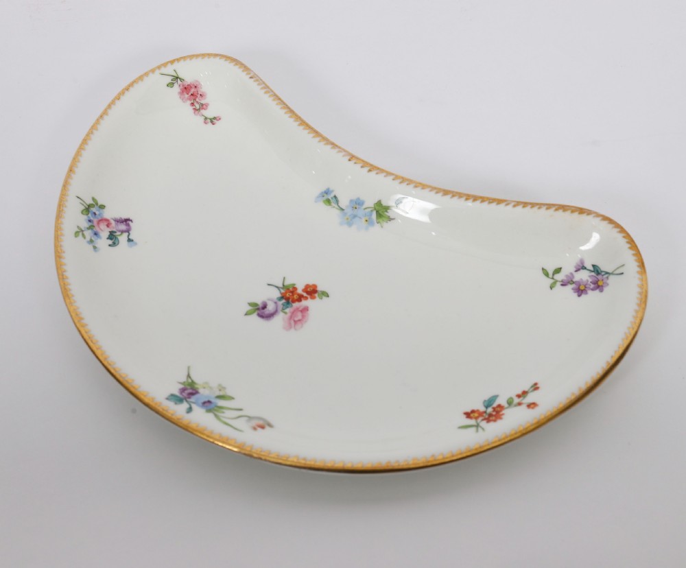 A 60-piece Victorian Copeland Spode white porcelain dinner service decorated with hand-painted floral bouquets, gilt rims, plates, crescent side dishes, and a covered tureen. View XV