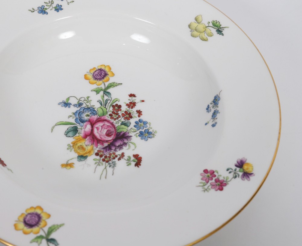 A 60-piece Victorian Copeland Spode white porcelain dinner service decorated with hand-painted floral bouquets, gilt rims, plates, crescent side dishes, and a covered tureen. View XVI