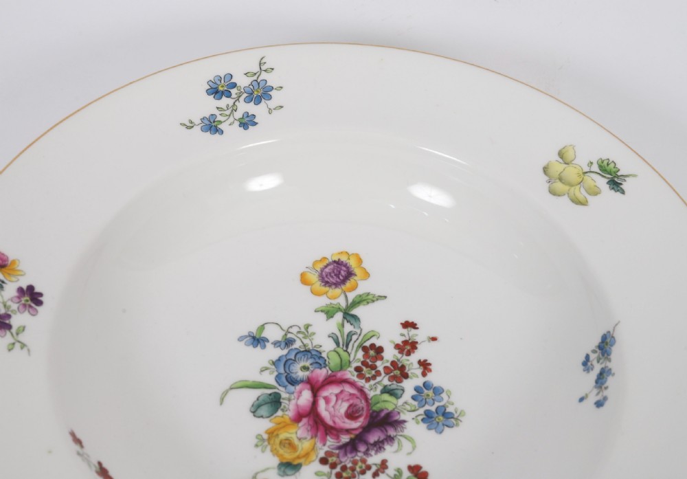 A 60-piece Victorian Copeland Spode white porcelain dinner service decorated with hand-painted floral bouquets, gilt rims, plates, crescent side dishes, and a covered tureen. View XVII