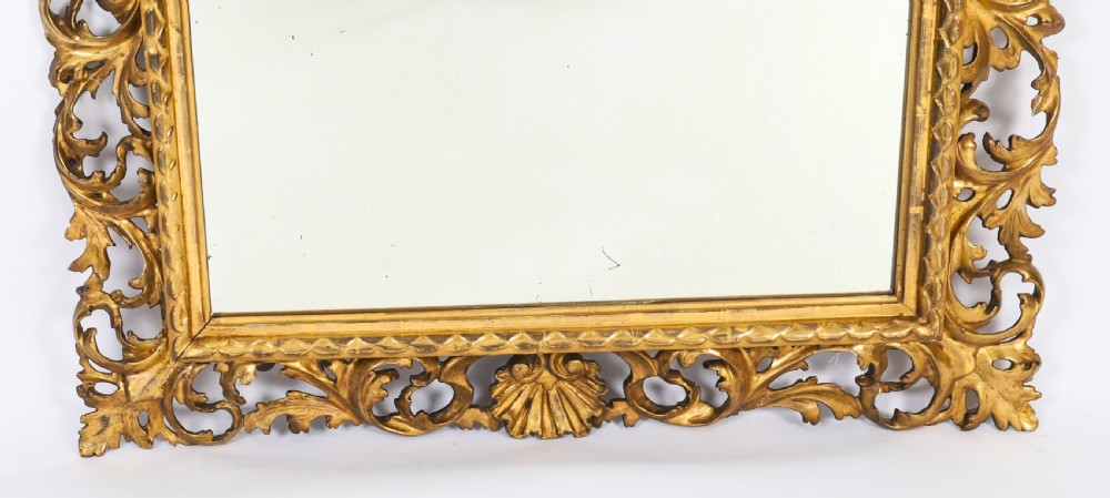 A rectangular 19th-century Italian giltwood wall mirror featuring an openwork frame carved with acanthus leaf scrolls and shell motifs. View VII