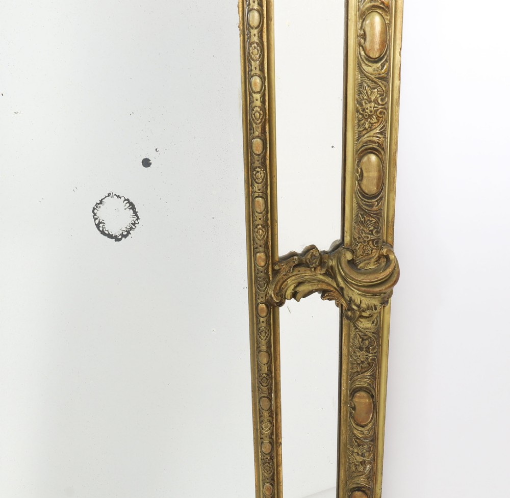 An antique French Louis Revival giltwood cushion overmantel mirror featuring a carved cresting, beaded inner frame, and marginal glass borders. View VIII