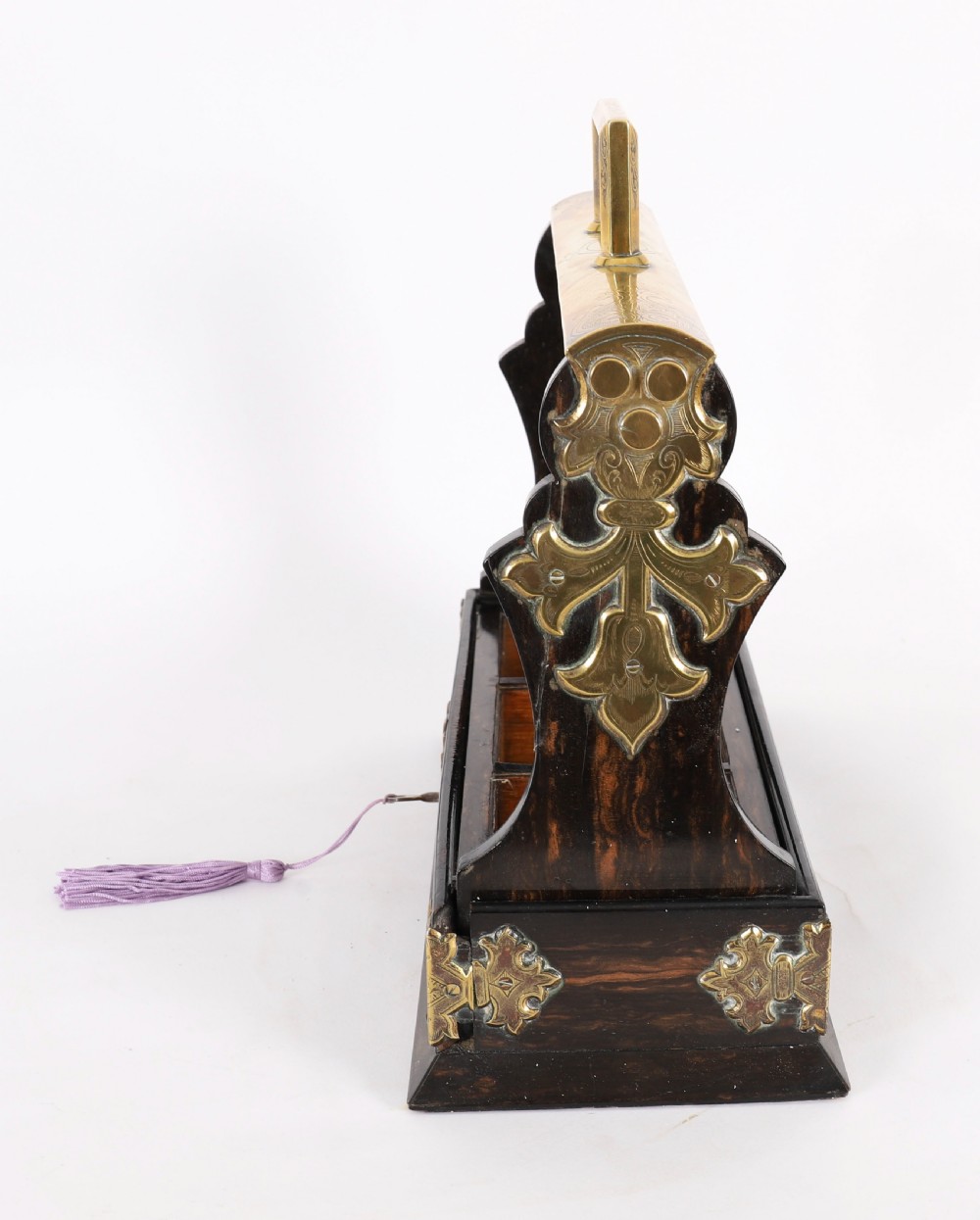 A Victorian coromandel wood tantalus with pierced brass corner mounts and top handle containing three cut crystal decanters with matching stoppers. View XIV
