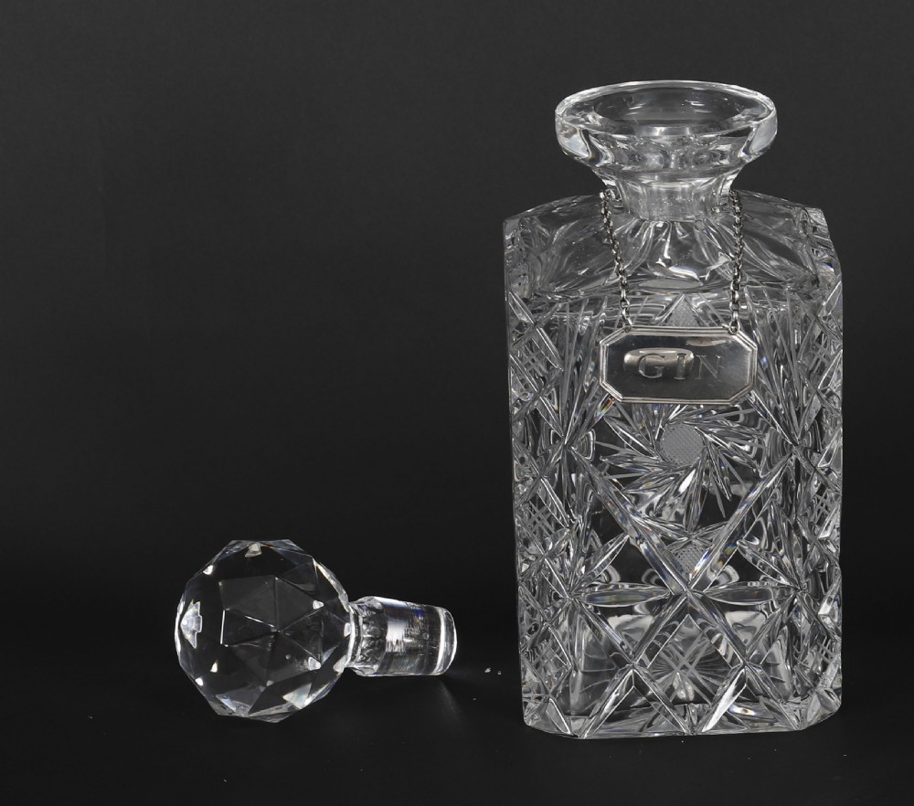 An Edwardian Betjemanns coromandel wood tantalus with hallmarked silver mounts holding three cut-crystal decanters. View VIII