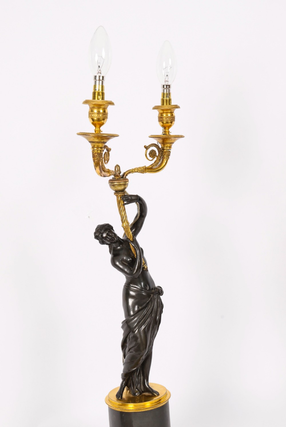 A pair of 19th-century French patinated bronze and gilt bronze two-light candelabra featuring classical draped female figures on cylindrical bases. View VII