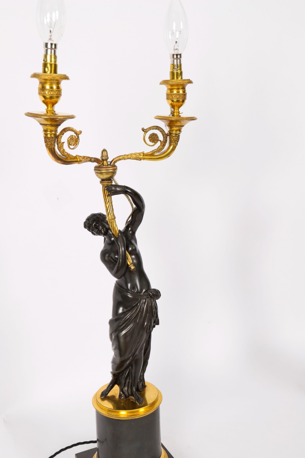 A pair of 19th-century French patinated bronze and gilt bronze two-light candelabra featuring classical draped female figures on cylindrical bases. View XII