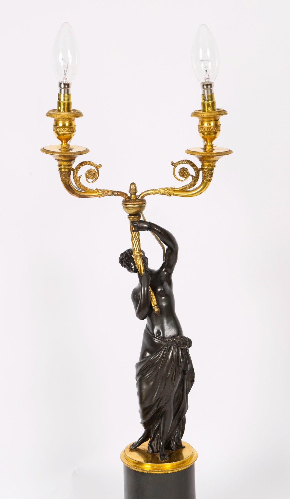 A pair of 19th-century French patinated bronze and gilt bronze two-light candelabra featuring classical draped female figures on cylindrical bases. View XIII