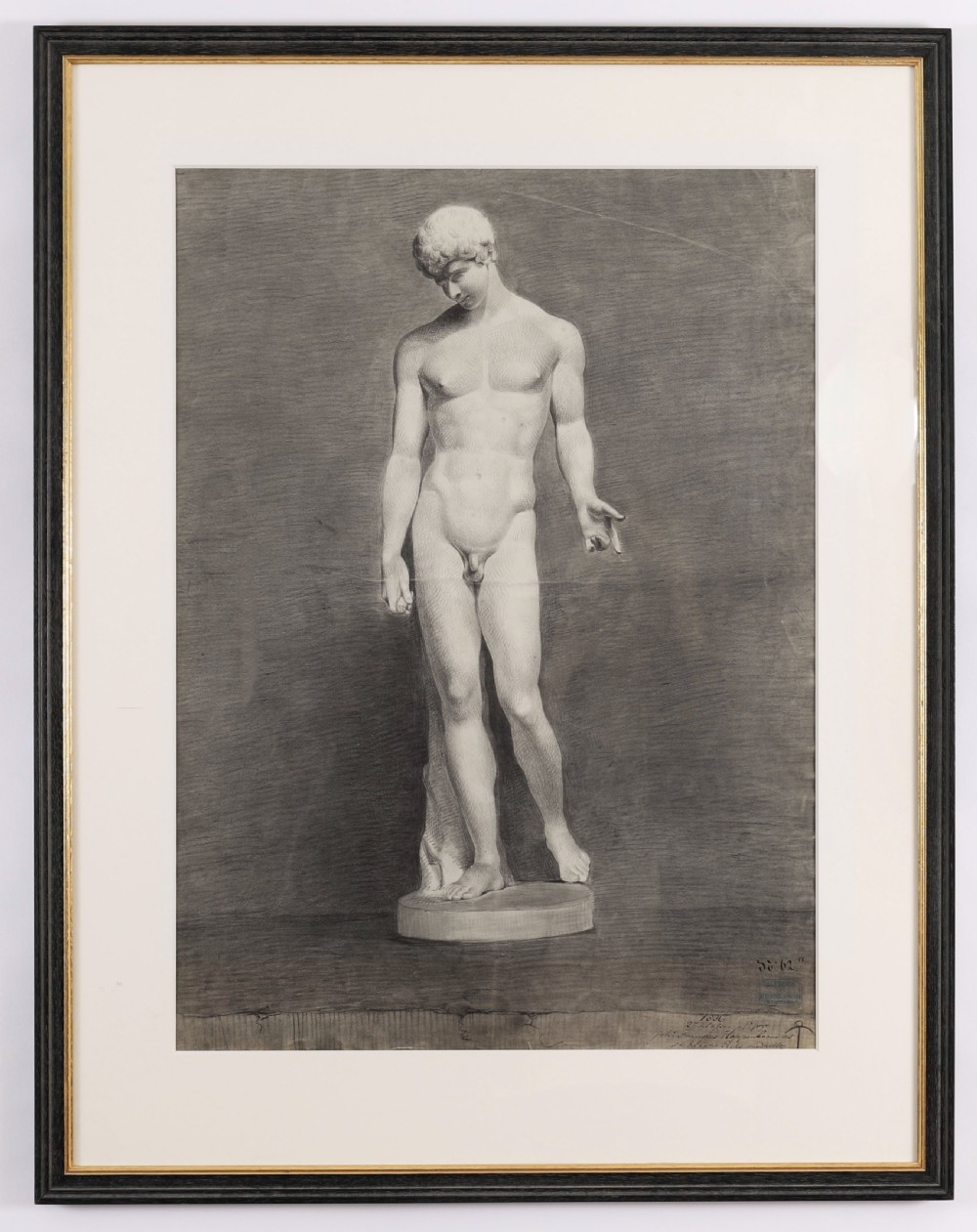 A monochrome charcoal drawing depicting a classical male nude sculpture in a black and gold frame with a cream mount.