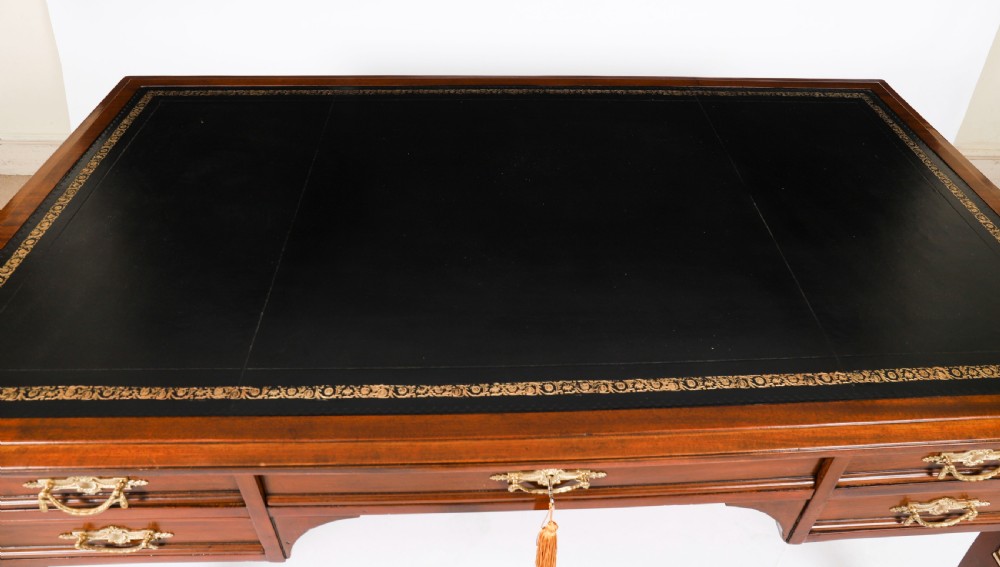 A nineteenth-century French Empire style mahogany bureau plat featuring gilt bronze ormolu mounts, tapered legs, five drawers, and a black leather writing surface. View III