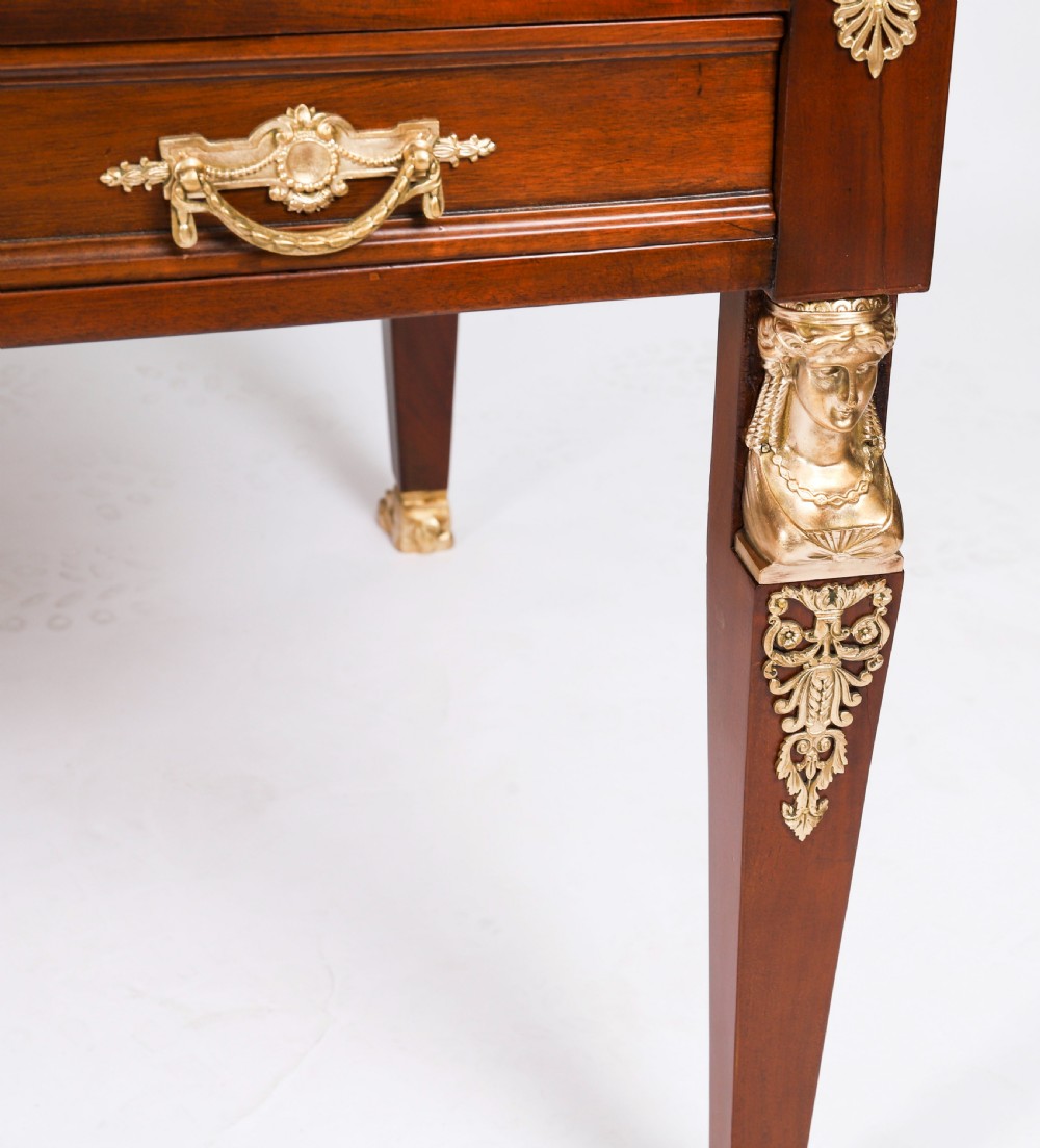 A nineteenth-century French Empire style mahogany bureau plat featuring gilt bronze ormolu mounts, tapered legs, five drawers, and a black leather writing surface. View XV