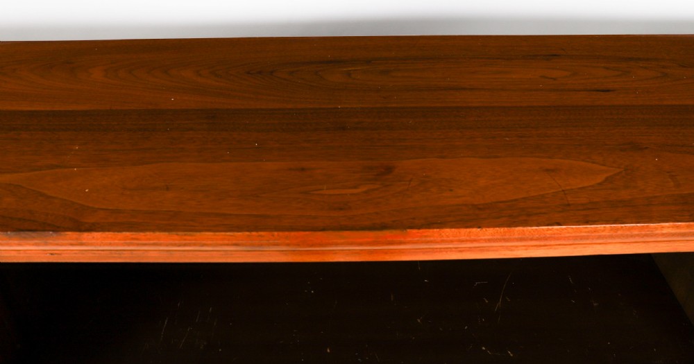 A wide Victorian open bookcase crafted in dark polished walnut with three bays of adjustable shelves, fluted pilasters adorned with circular ormolu mounts, and short turned feet. View V