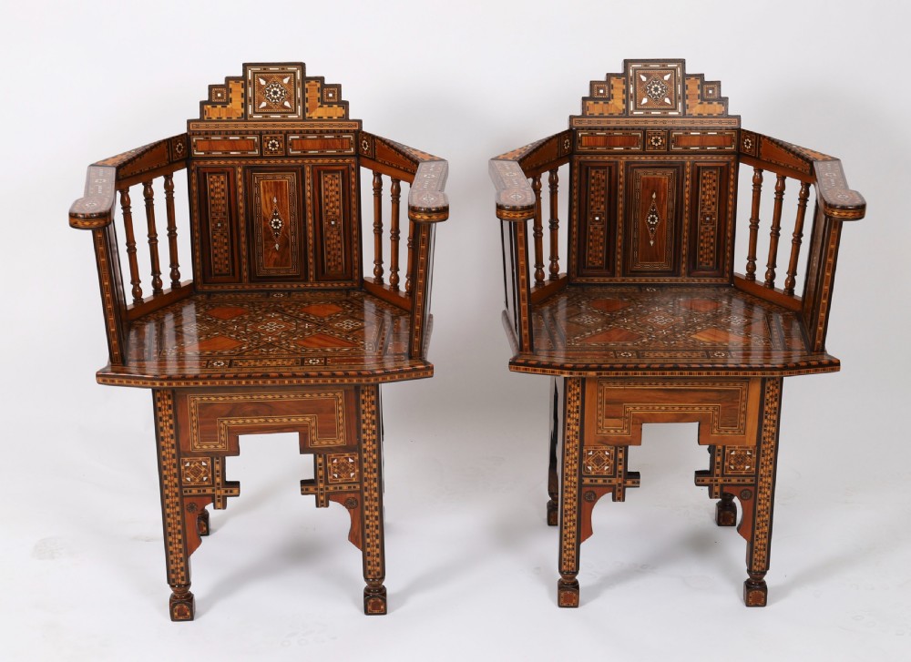 A pair of 19th-century Levantine armchairs decorated with geometric wood parquetry, mother-of-pearl inlay, turned side spindles, and stepped crest rails. View II