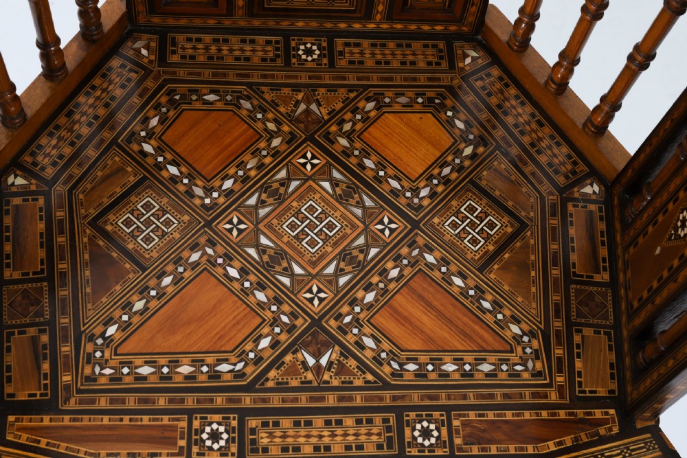 A pair of 19th-century Levantine armchairs decorated with geometric wood parquetry, mother-of-pearl inlay, turned side spindles, and stepped crest rails. View VII